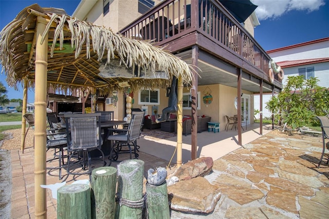 view of patio / terrace with a balcony, an outdoor hangout area, and outdoor dining space