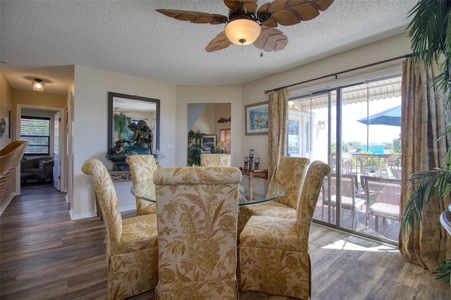 dining room with ceiling fan, dark hardwood / wood-style flooring, and a textured ceiling