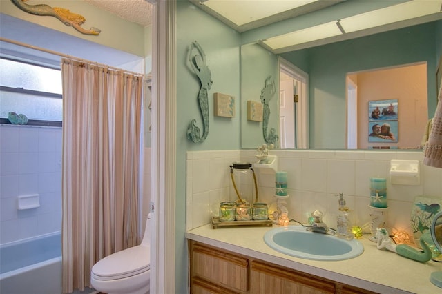 full bathroom with vanity, backsplash, shower / bath combination with curtain, and toilet