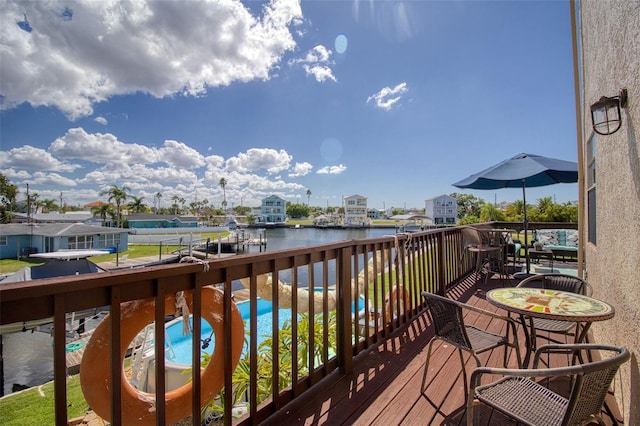 wooden deck featuring a water view