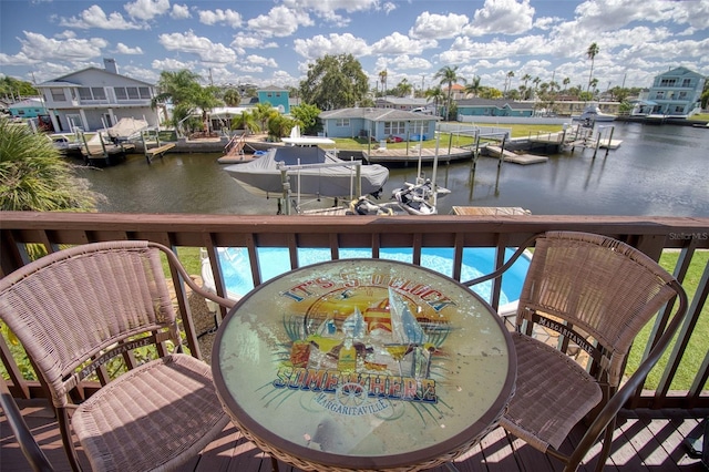 balcony featuring a water view and a boat dock