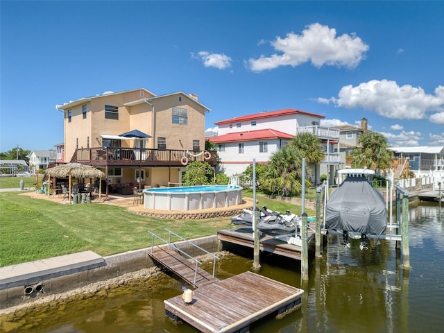 view of dock with a patio, boat lift, a water view, a lawn, and an outdoor pool