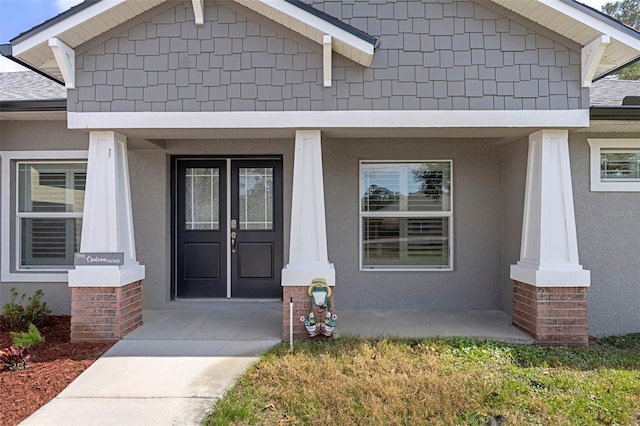 view of exterior entry with a porch