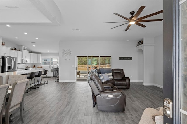 living room with light hardwood / wood-style flooring and ceiling fan