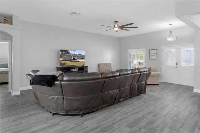 living room with ceiling fan and french doors