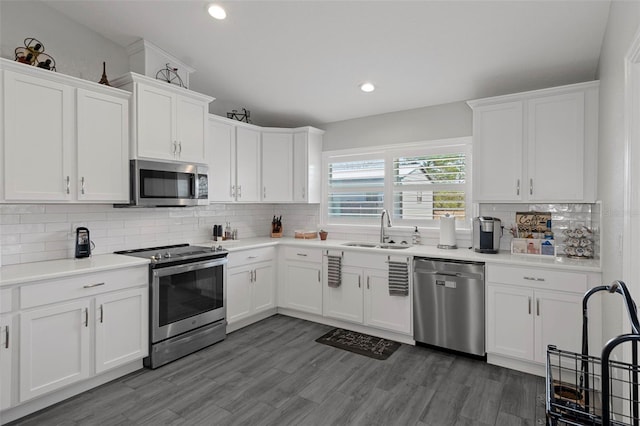 kitchen featuring white cabinetry, sink, backsplash, and appliances with stainless steel finishes