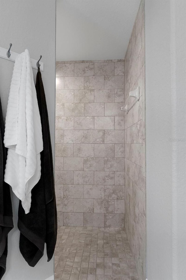 bathroom with tiled shower