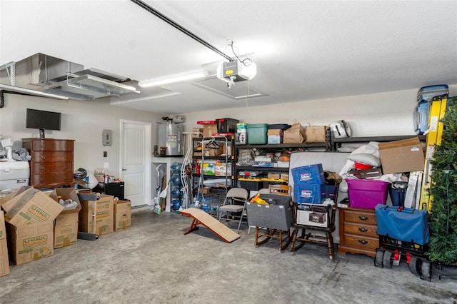 garage with a garage door opener and electric water heater