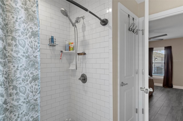 bathroom featuring tiled shower, hardwood / wood-style floors, and ceiling fan