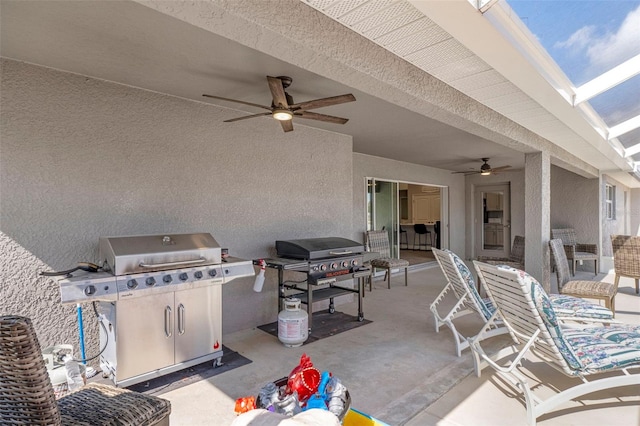 view of patio with ceiling fan and area for grilling