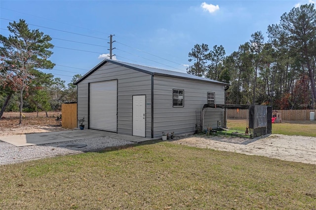 exterior space featuring a garage and a lawn