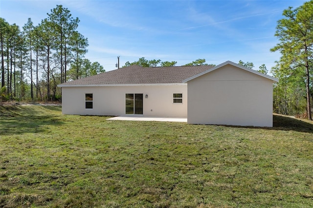 back of house with a patio and a yard