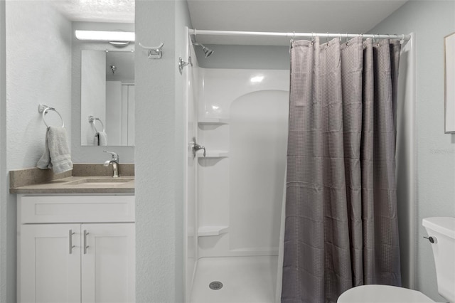 bathroom featuring vanity, toilet, and a shower with shower curtain