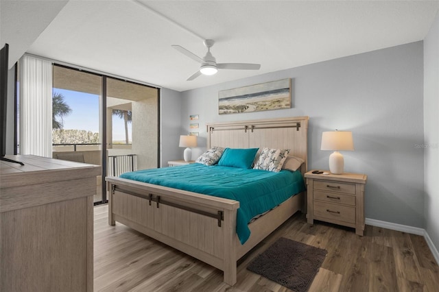 bedroom with hardwood / wood-style floors, access to outside, floor to ceiling windows, and ceiling fan