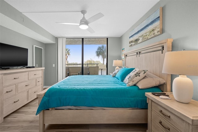 bedroom with expansive windows, ceiling fan, light hardwood / wood-style floors, and access to outside