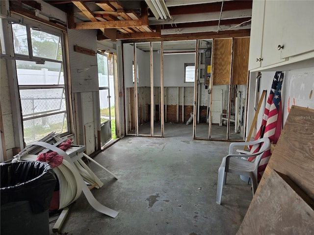 miscellaneous room featuring concrete floors and a healthy amount of sunlight