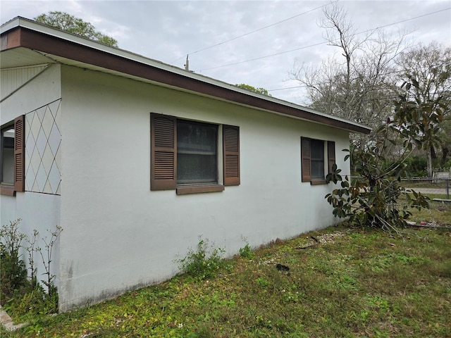 view of side of home with a lawn