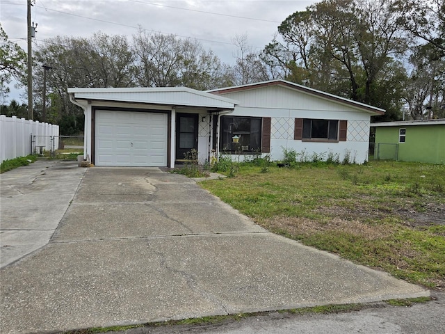 ranch-style home with a garage and a front lawn