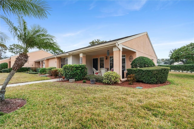 single story home featuring covered porch and a front lawn