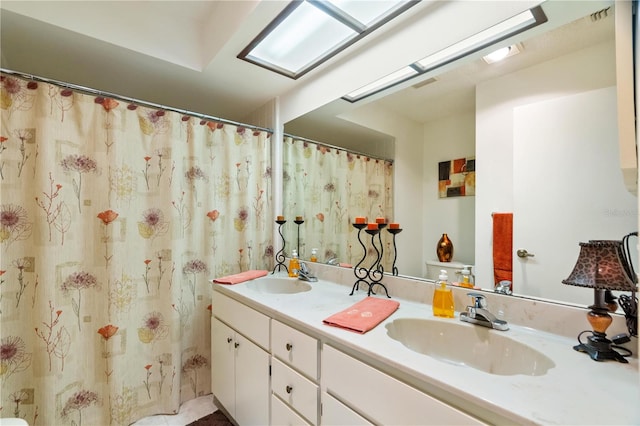 bathroom featuring vanity and a skylight