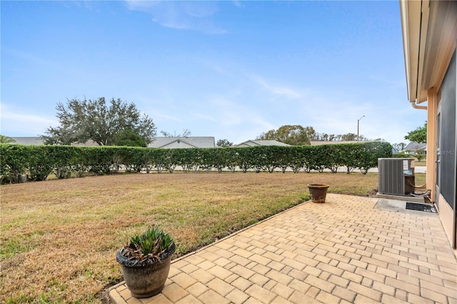 view of yard with cooling unit and a patio area