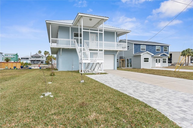 back of property with a garage, a yard, and a porch