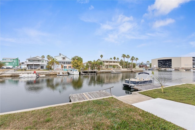 dock area featuring a water view and a lawn