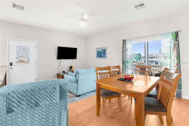 dining room with light hardwood / wood-style floors and ceiling fan