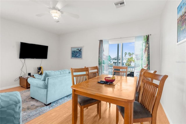 dining area with ceiling fan and light wood-type flooring