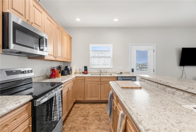 kitchen with light brown cabinetry, sink, and appliances with stainless steel finishes