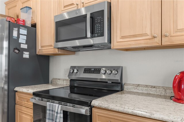 kitchen featuring appliances with stainless steel finishes and light brown cabinets