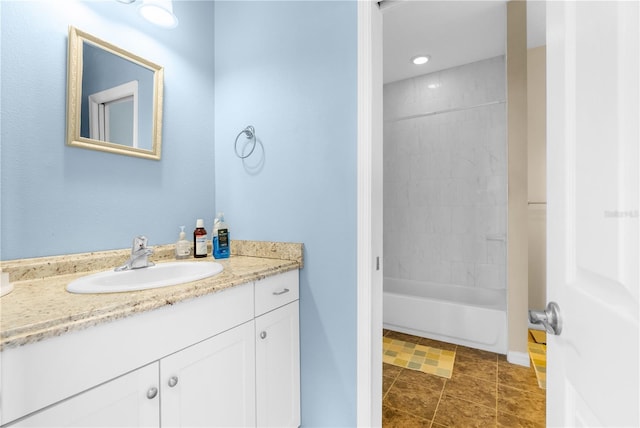 bathroom featuring vanity, tiled shower / bath combo, and tile patterned floors