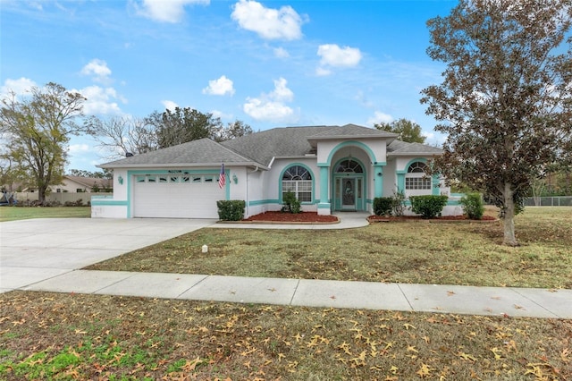 view of front facade with a garage and a front lawn