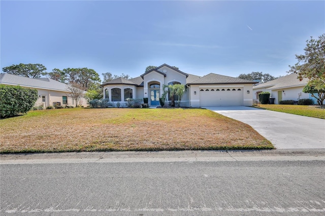 view of front of home featuring a garage and a front yard