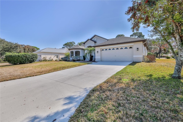 view of front of home featuring a garage and a front lawn