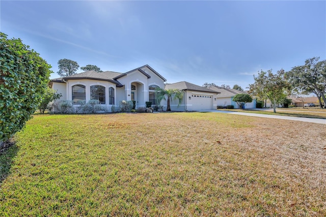 view of front of home featuring a garage and a front yard