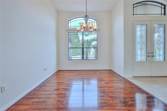 entryway featuring dark hardwood / wood-style flooring and a notable chandelier