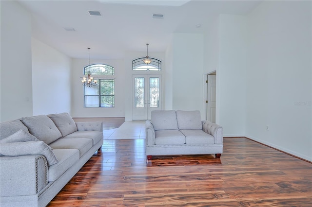 living room with dark hardwood / wood-style floors and french doors