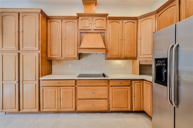 kitchen with black electric stovetop, decorative backsplash, custom exhaust hood, and stainless steel refrigerator with ice dispenser