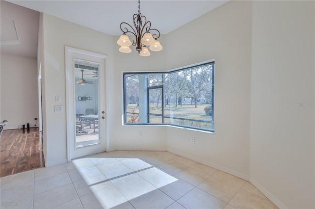 unfurnished dining area with a chandelier and light tile patterned floors