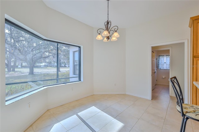 dining room with an inviting chandelier, a wealth of natural light, and light tile patterned flooring