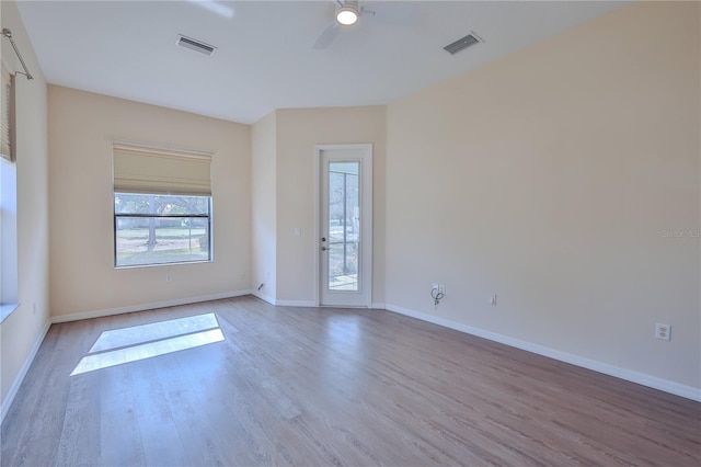 spare room featuring light hardwood / wood-style flooring and ceiling fan