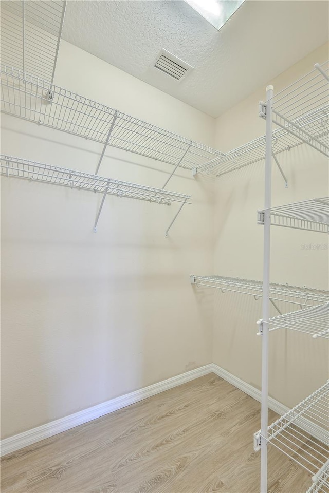 walk in closet featuring wood-type flooring