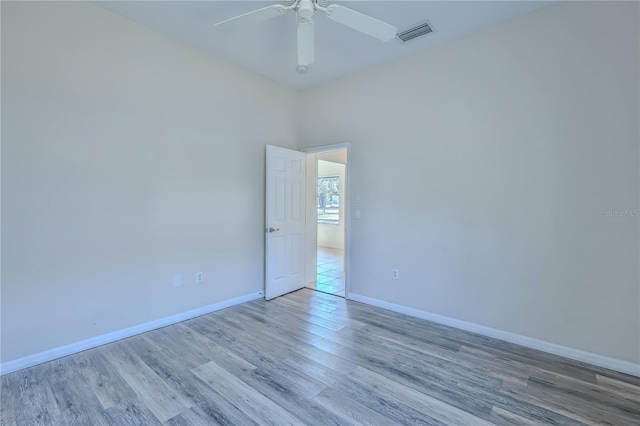 empty room featuring ceiling fan and light hardwood / wood-style flooring