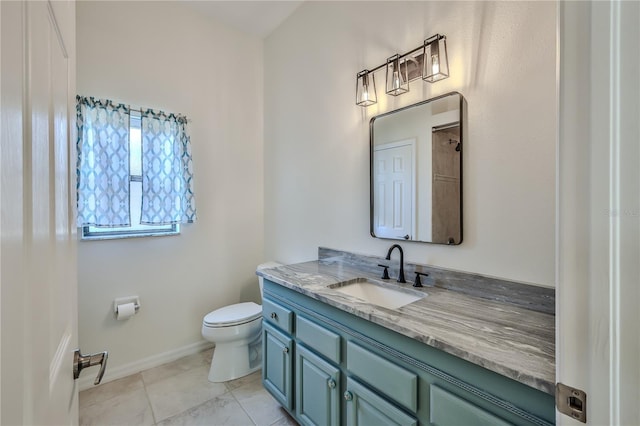 bathroom featuring vanity, tile patterned floors, and toilet