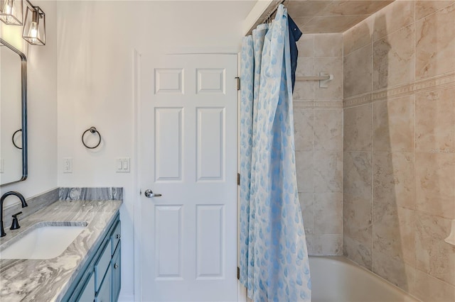 bathroom with shower / tub combo and vanity