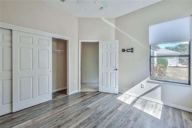 unfurnished bedroom with hardwood / wood-style floors and a closet