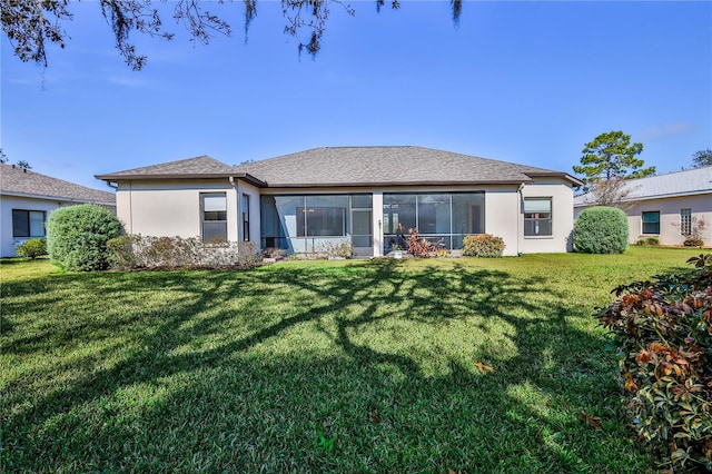 rear view of property featuring a lawn