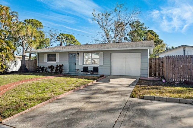 ranch-style home featuring a garage, fence, concrete driveway, and a front yard