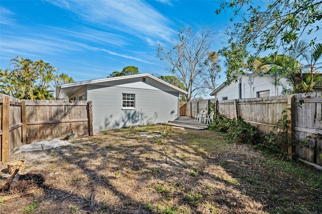 rear view of house with a fenced backyard